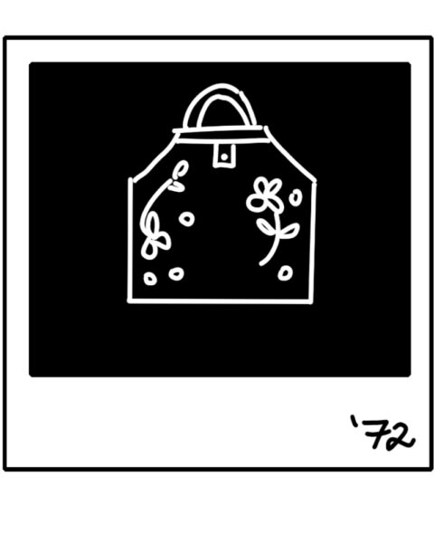 In black and white. An illustrations of a Polaroid of an decorated apron with "'72'" written in the bottom right corner.